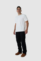 Man wearing a white t-shirt, black pants, and brown shoes on a white background