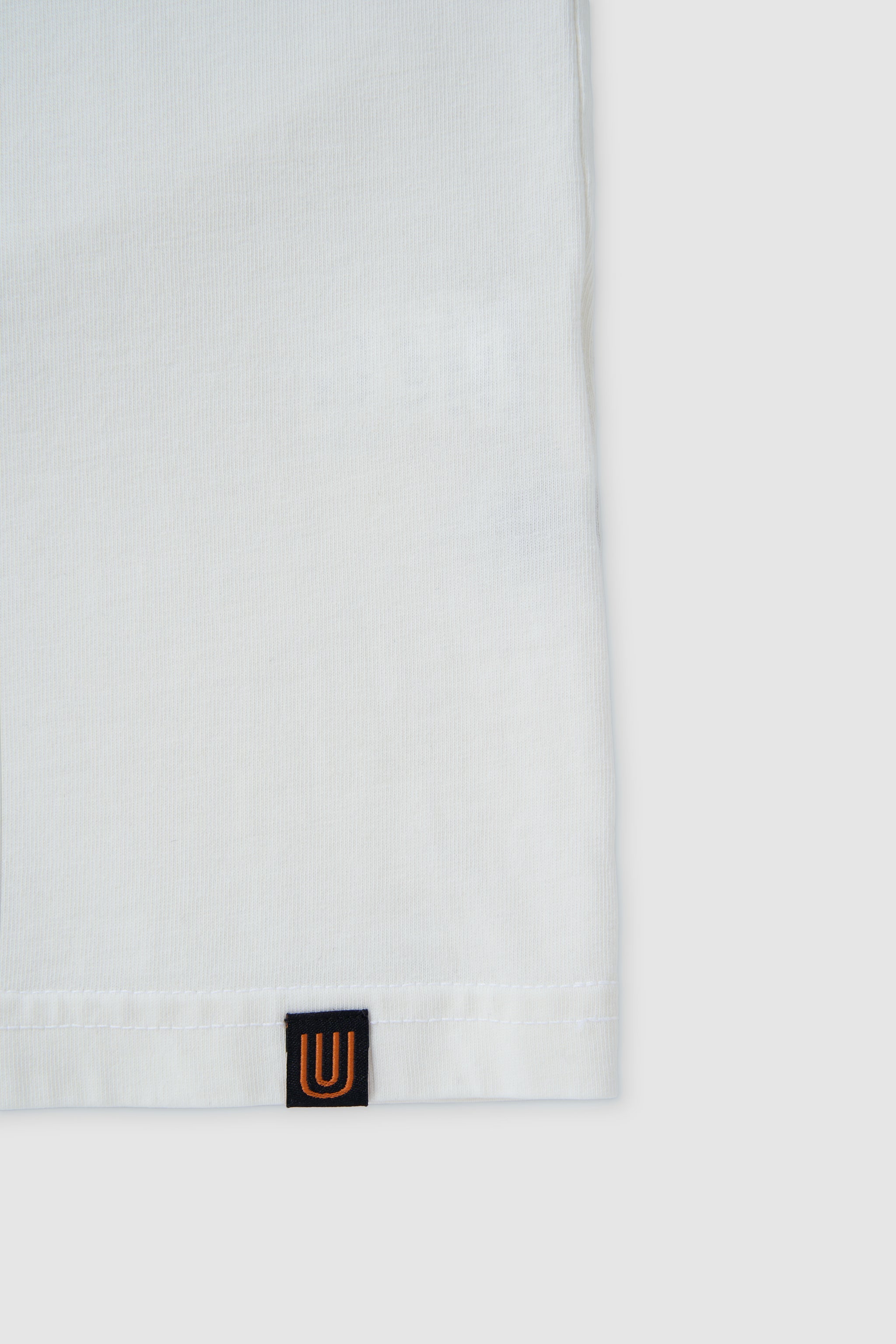 White hoodie with a small logo on the chest against a white background