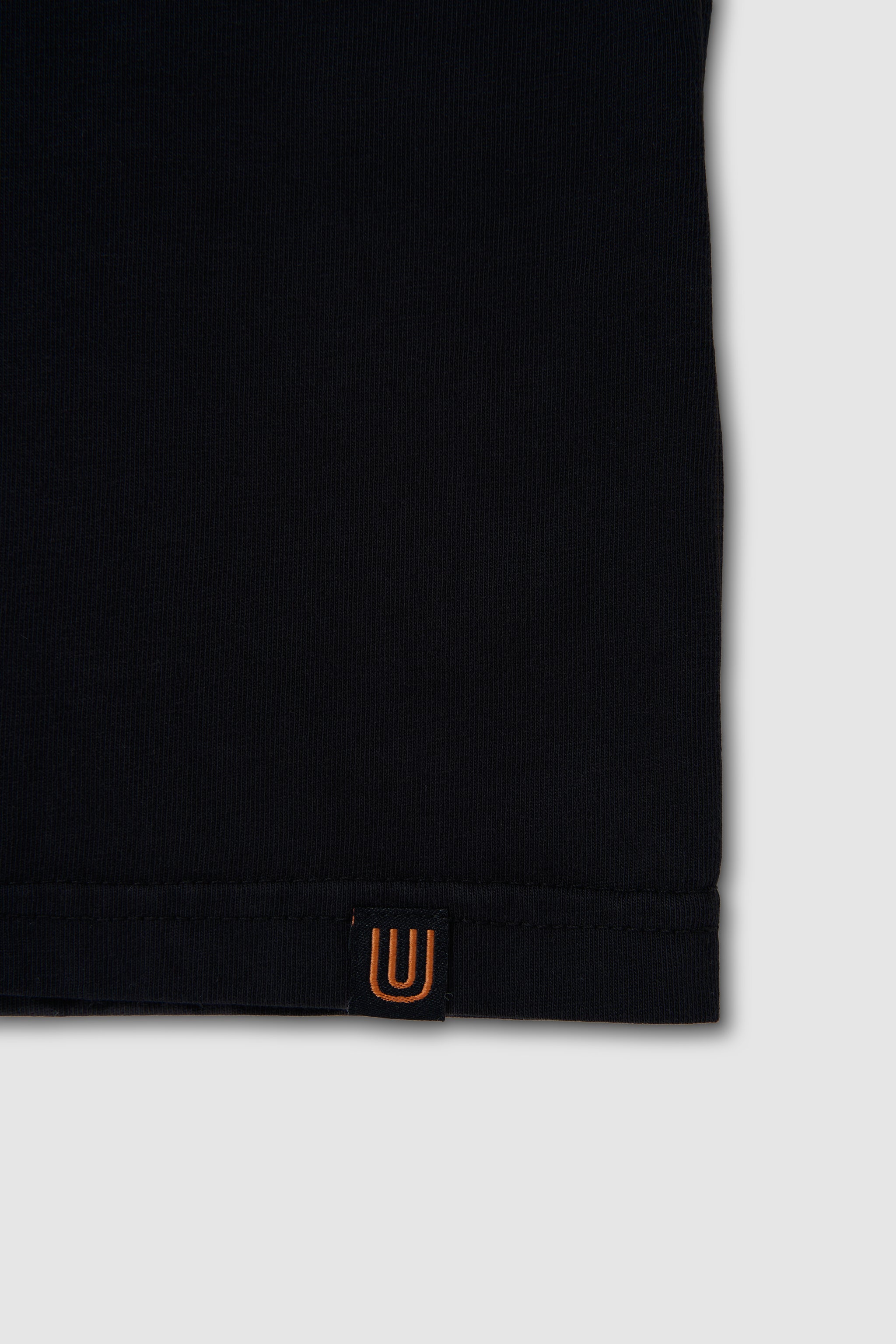 Black sleeve with a small orange logo on a white background