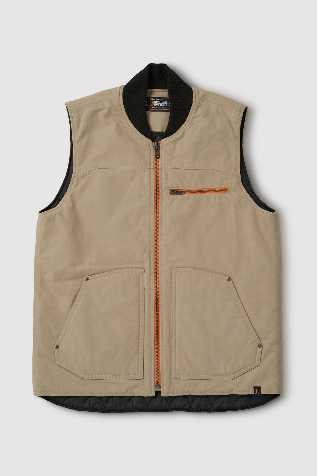 Beige vest with black trim and orange zipper on a light gray background