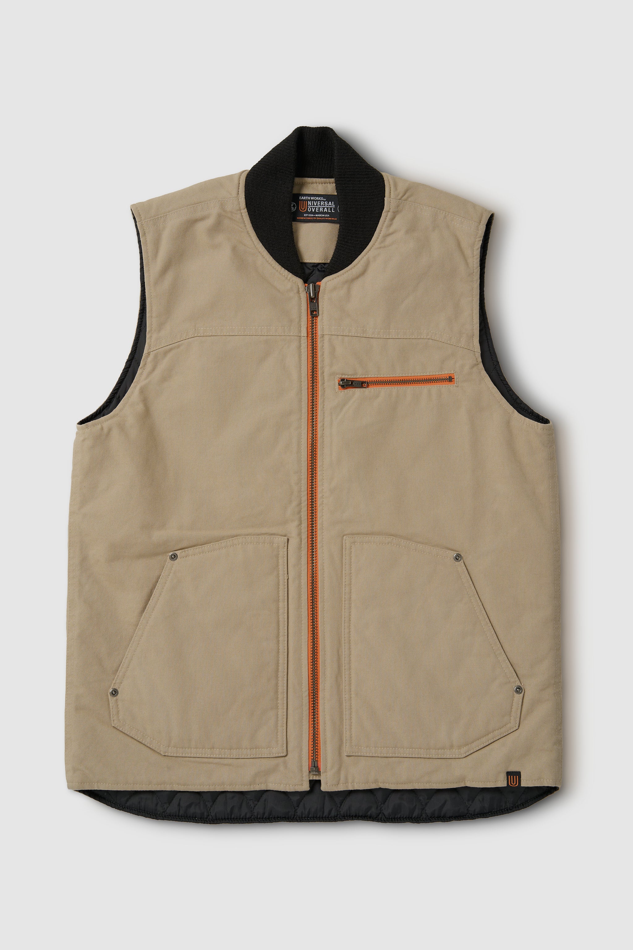 Beige vest with black trim and orange zipper on a light gray background