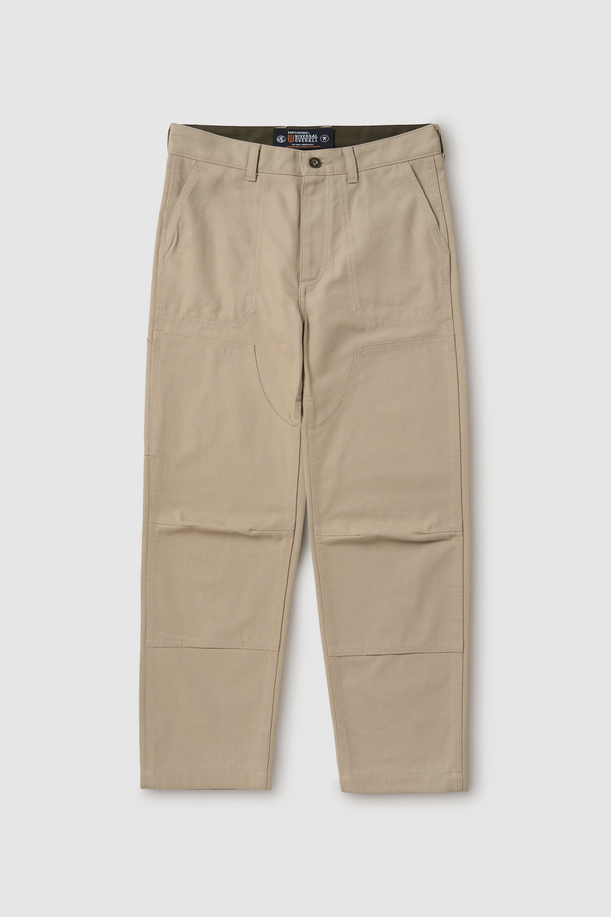 Beige pants with a visible brand label on a white background