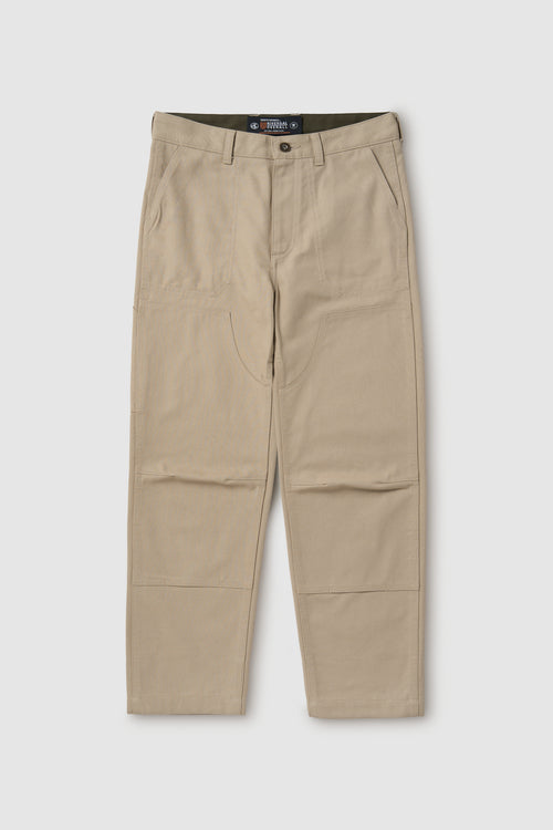 Beige pants with a visible brand label on a white background